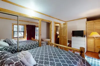 a bedroom with two beds and a television in it at Ski Run Village 11 in South Lake Tahoe