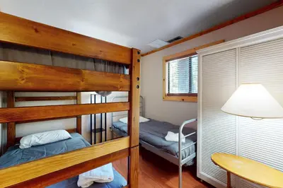 a bedroom with two bunk beds and a table at Ski Run Village 11 in South Lake Tahoe