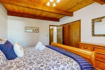 a bedroom with a bed and a wooden ceiling at Wolfgang Dreams in Truckee