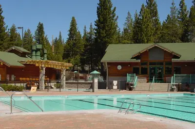 a large swimming pool in front of a lodge at Wolfgang Dreams in Truckee