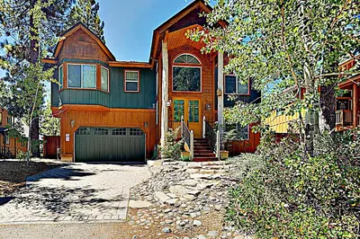 a large house with a garage in front of it at Koyukon Escape in South Lake Tahoe