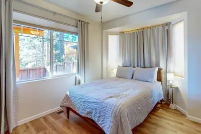 a bedroom with a bed and a large window at Koyukon Escape in South Lake Tahoe