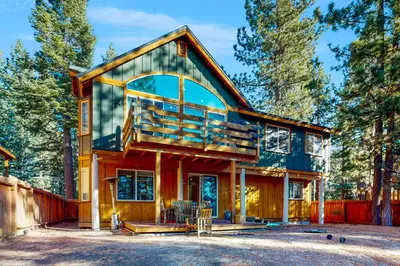 a house with a wrap around porch with a deck at Koyukon Escape in South Lake Tahoe