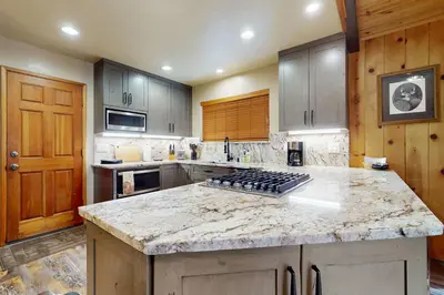 a large kitchen with a counter top and a stove at Cozy Tahoe Donner Retreat in Truckee