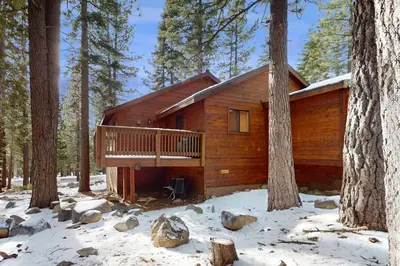 a log cabin in the woods in the snow at Cozy Tahoe Donner Retreat in Truckee