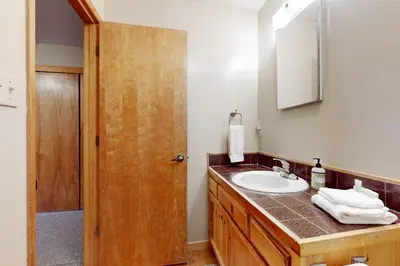a bathroom with a sink and a mirror at Cozy Tahoe Donner Retreat in Truckee