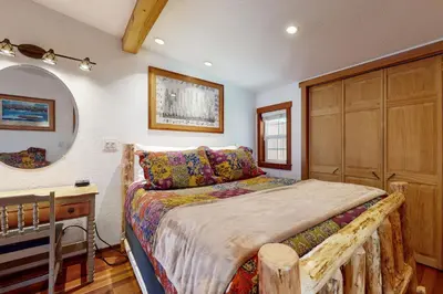 a bedroom with a bed with a dresser and a desk at Pioneer Palace in South Lake Tahoe