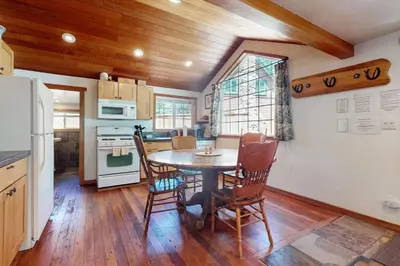 a kitchen with a table and chairs in a room at Pioneer Palace in South Lake Tahoe