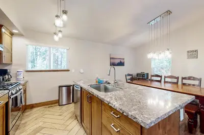 a kitchen with a sink and a counter top at Homewood Cabin Among the Pines in Homewood