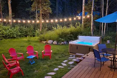 a group of chairs and a pool in a yard at Homewood Cabin Among the Pines in Homewood