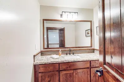 a bathroom with a sink and a large mirror at Prospector Palace in South Lake Tahoe