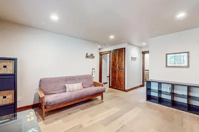 a living room with a couch and a table at Prospector Palace in South Lake Tahoe