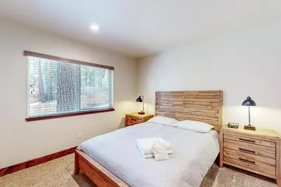 a bedroom with a large bed and a window at Prospector Palace in South Lake Tahoe