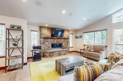 a living room with a couch and a fireplace at Prospector Palace in South Lake Tahoe
