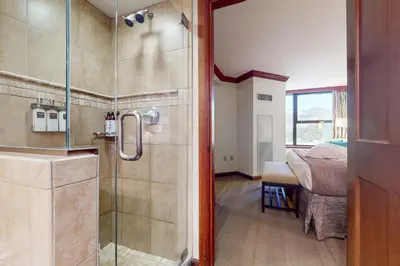 a bathroom with a shower with a glass door at Resort at Squaw Creek's 806 & 808 in Olympic Valley