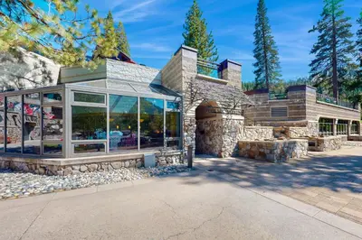 a home with a stone building with glass windows at Resort at Squaw Creek's 806 & 808 in Olympic Valley