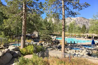 a swimming pool in a resort with trees at Resort at Squaw Creek's 605 in Olympic Valley