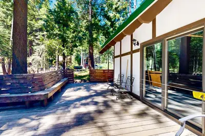 a porch with benches and a building with trees at Alpine Haven in Tahoe City