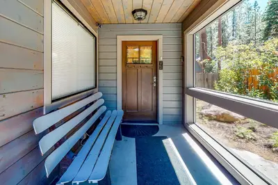 a bench sits on the front porch of a house at Golden Adventures in Kings Beach