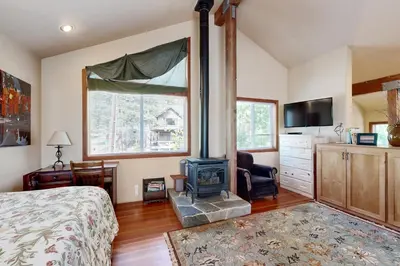 a bedroom with a bed and a wood stove in it at Silverado Escape in Tahoe City