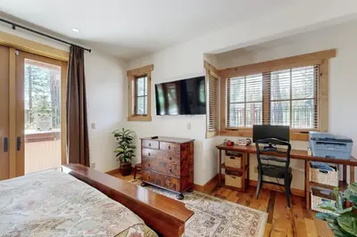 a bedroom with a bed and a desk with a computer at Mount Olympia Oasis in South Lake Tahoe