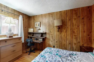 a bedroom with a bed and a desk and a chair at Pineland Escape in Tahoe City