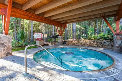 a hot tub in a patio with a wooden roof at Northstar Resort 207 in Truckee