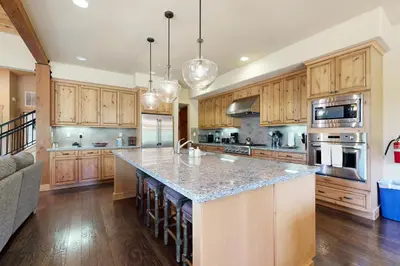 a large kitchen with wooden cabinets and a large island at Sagebrush Charms in Truckee
