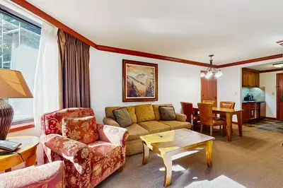 a living room with a couch and a table at Resort at Squaw Creek's 317 & 319 in Olympic Valley