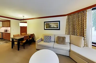 a living room with a couch and a table at Resort at Squaw Creek's 521 in Olympic Valley