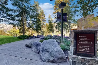 a sign in a park with rocks on a sidewalk at Resort at Squaw Creek's 521 in Olympic Valley