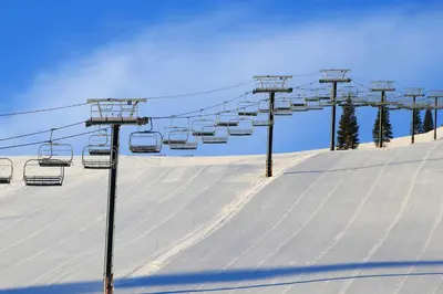a ski lift on top of a snow covered slope at Tahoe Donner Snow Globe in Truckee