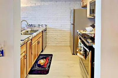 a kitchen with a sink and a refrigerator at Cove 141 in South Lake Tahoe
