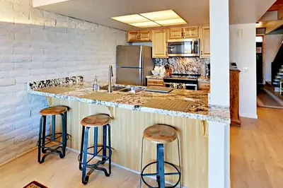 a kitchen with a counter and two stools at Cove 141 in South Lake Tahoe