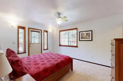 a bedroom with a bed and a ceiling fan at Northwoods Paradise in Truckee