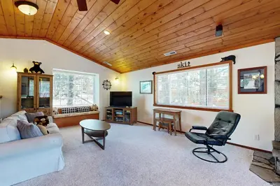 a living room with a couch and a chair at Northwoods Paradise in Truckee