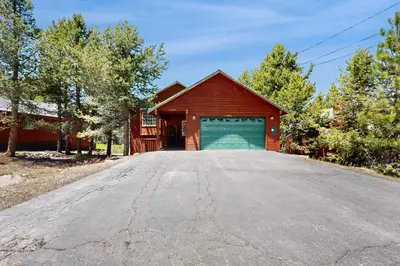 a red barn with a garage on a road at Northwoods Paradise in Truckee