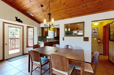 a kitchen and dining room with a wooden table and chairs at Northwoods Paradise in Truckee