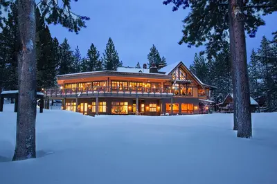 a large house in the snow at night at Northwoods Paradise in Truckee