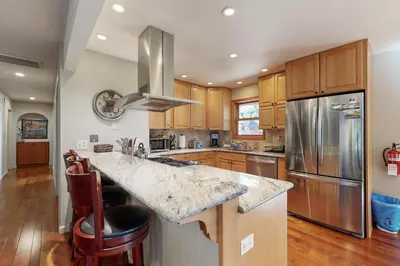 a kitchen with a granite counter top and stainless steel refrigerator at Zermatt Getaway in Truckee