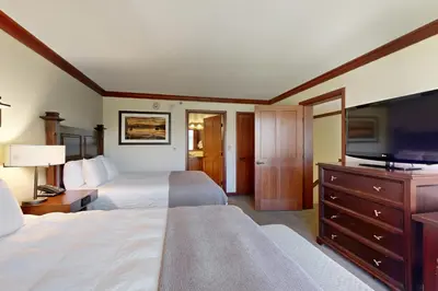 a hotel room with two beds and a flat screen tv at Resort at Squaw Creek's 810 & 812 in Olympic Valley