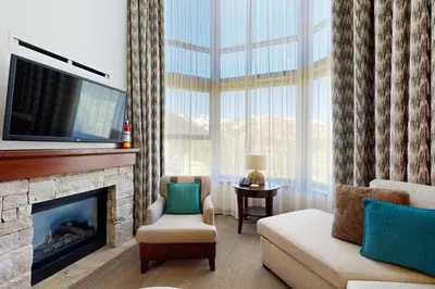 a living room with a fireplace and a television at Resort at Squaw Creek's 810 & 812 in Olympic Valley