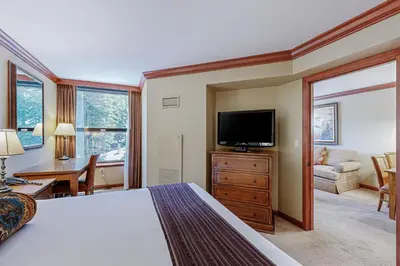 a bedroom with a bed and a flat screen tv at Resort at Squaw Creek's 605 & 607 in Olympic Valley