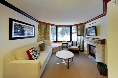 a living room with a couch and a fireplace at Resort at Squaw Creek's 521 & 523 in Olympic Valley