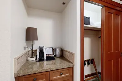 a room with a counter with a coffee maker and a lamp at Resort at Squaw Creek's 521 & 523 in Olympic Valley