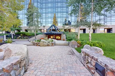 a garden with a building in the background at Resort at Squaw Creek's 521 & 523 in Olympic Valley