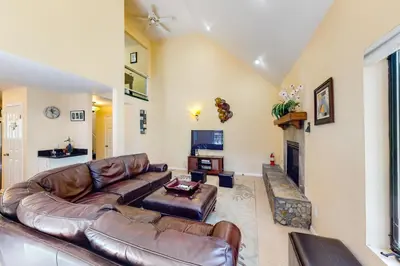 a living room with a leather couch and a fireplace at Pathway Paradise in Truckee