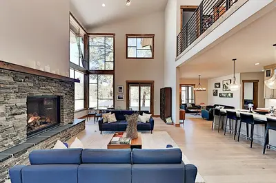 a living room with blue couches and a fireplace at Henness Haven in Truckee