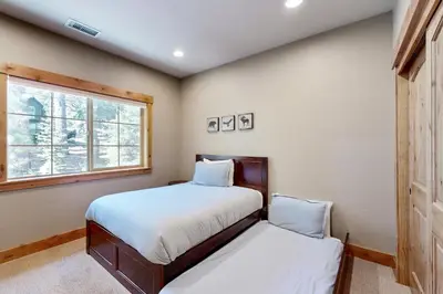 a bedroom with two beds and a window at Walk-Friendly Truckee House in Truckee