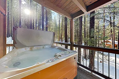 a hot tub on a screened in porch with trees at High Meadows Retreat in South Lake Tahoe